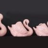 Set of four large, medium and small pink swans