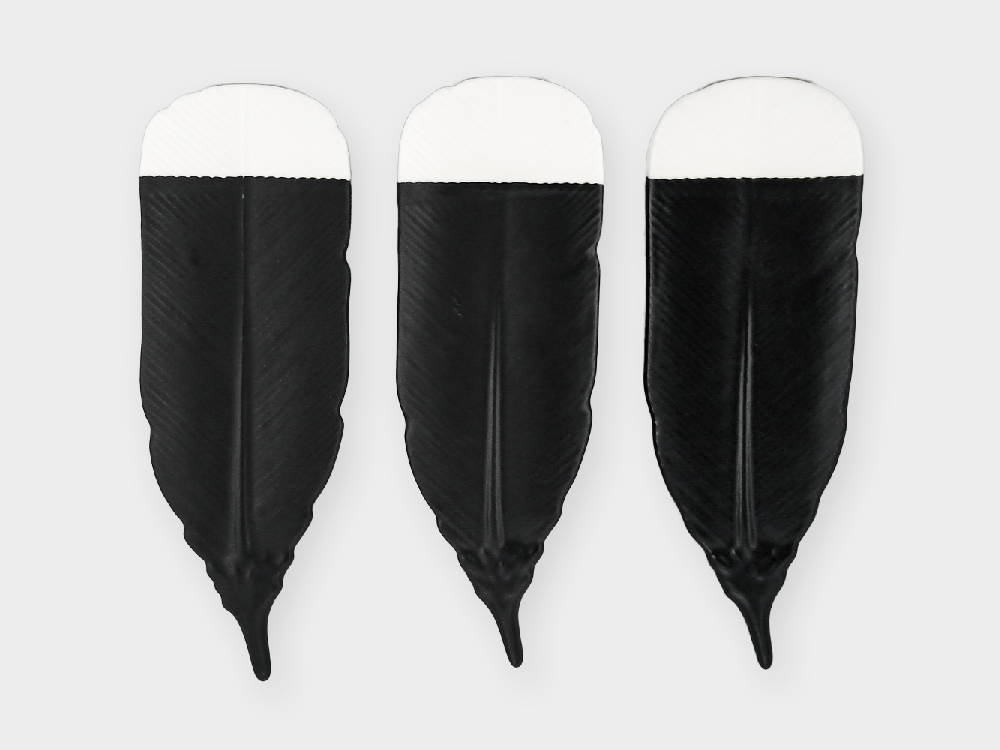 Three huia feathers made by Crown Lynn Kiwi